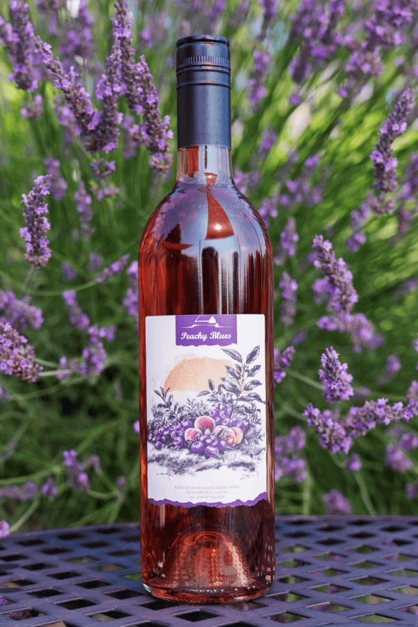 bottle of Peachy Blues with lavender in background