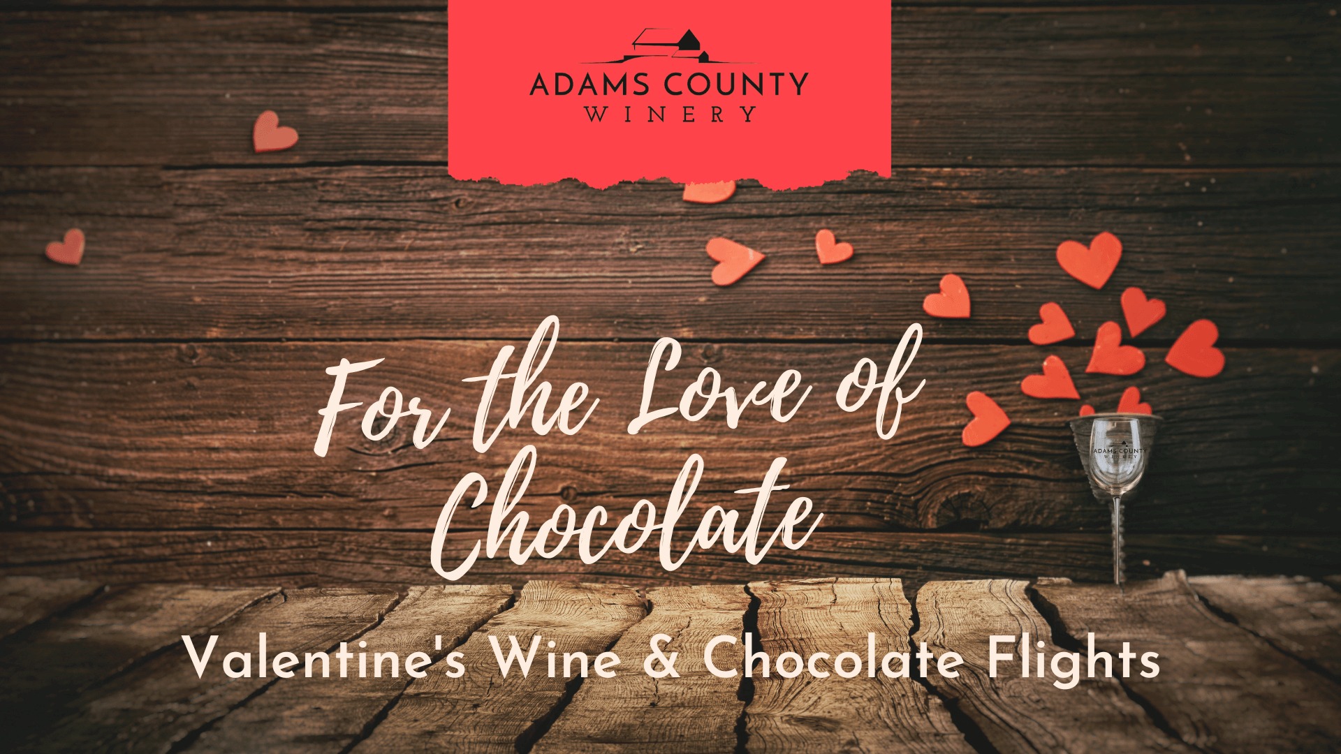 For the Love of Chocolate seated wine and chocolate pairing. Hearts, wine bottle, glass and roses in the background.