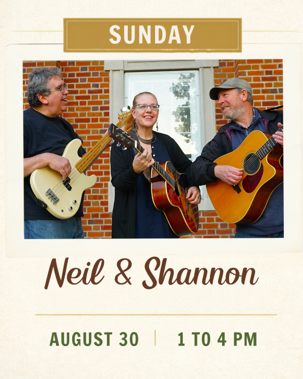 Two guys with guitars facing a girl with a guitar in the middle.