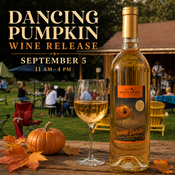 bottle of Dancing Pumpkin and glass of wine with the band and grounds in the background