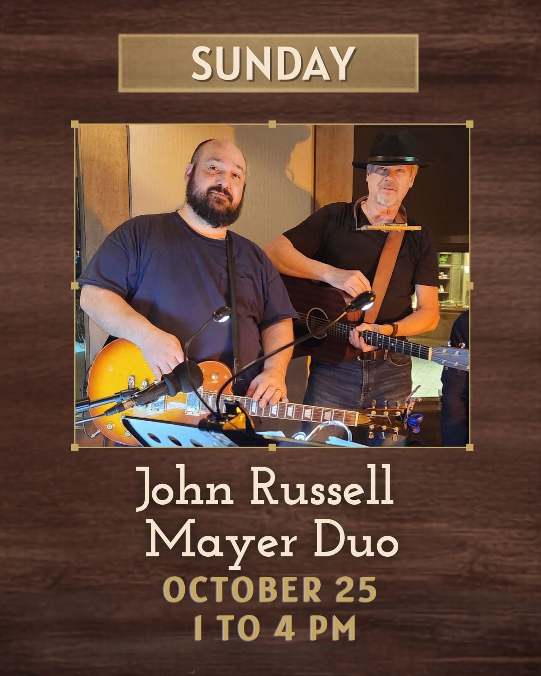 Two men with guitars are standing in an interior location facing the camera.